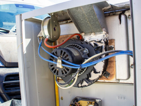 Furnace inducer motor and pressure switch with scorched, peeling housing found during a furnace tune-up in San Diego