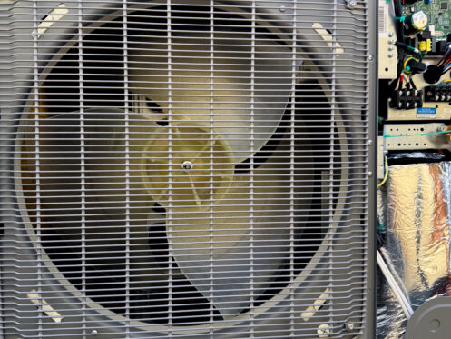 Close-up of an AC unit in Santee, CA being serviced to diagnose why it’s blowing warm air.